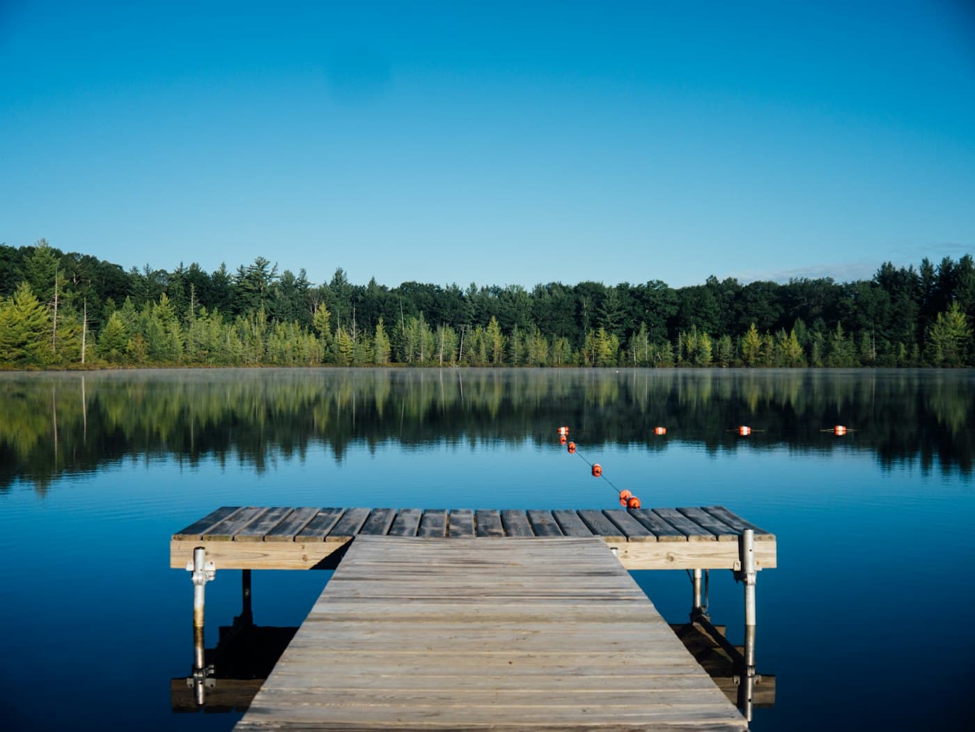 Still lake and a wooden jetty